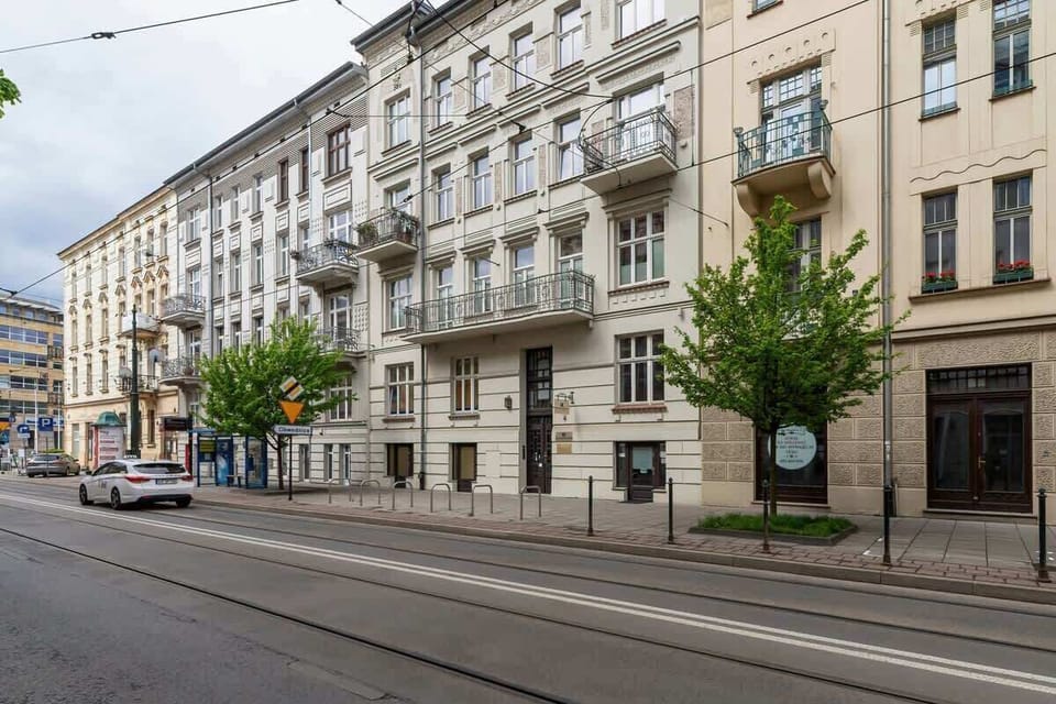 The building’s historic façade from a street perspective, showcasing ornate architectural details.
