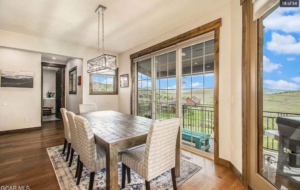 Dining table with room for 8, plus additional seating at the bar. There are also  dining tables on the deck and in the downstairs family room. 