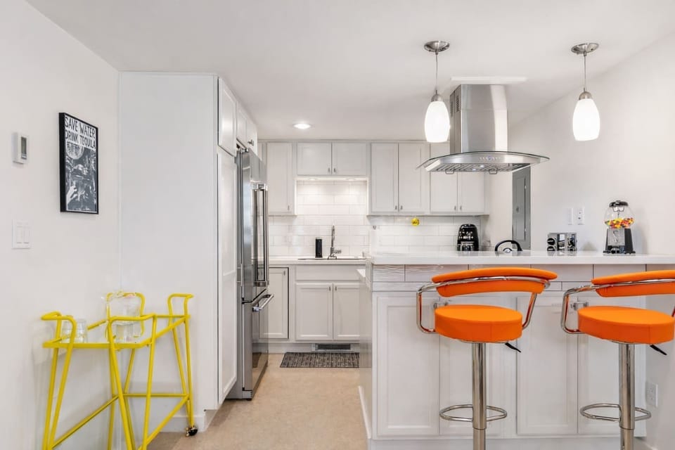 Start your day in this bright kitchen with modern appliances and a cozy breakfast bar for coffee or casual meals.