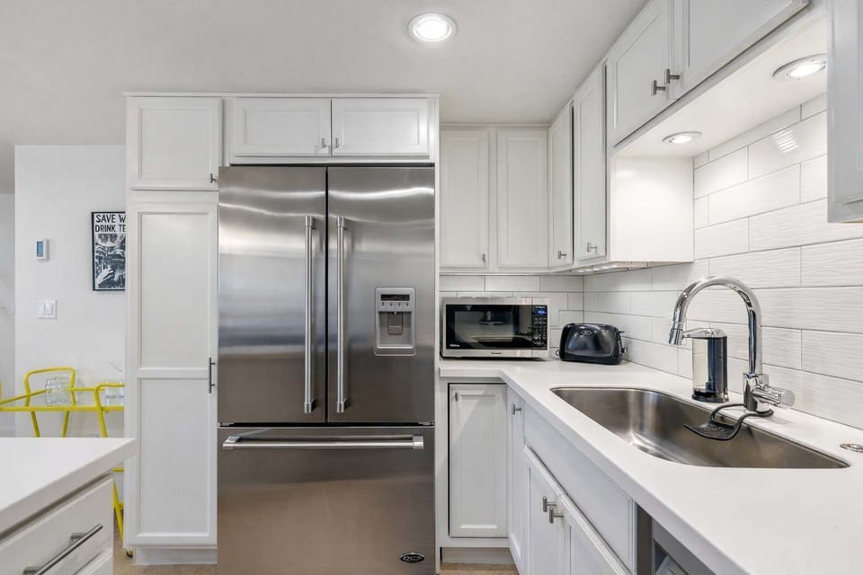 Prepare meals with ease in this bright kitchen featuring modern appliances and thoughtful design.