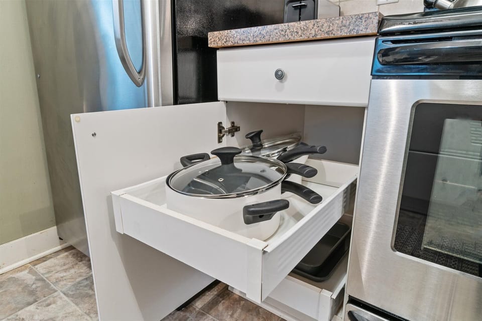 Pots and pans available tucked away at the kitchen drawer