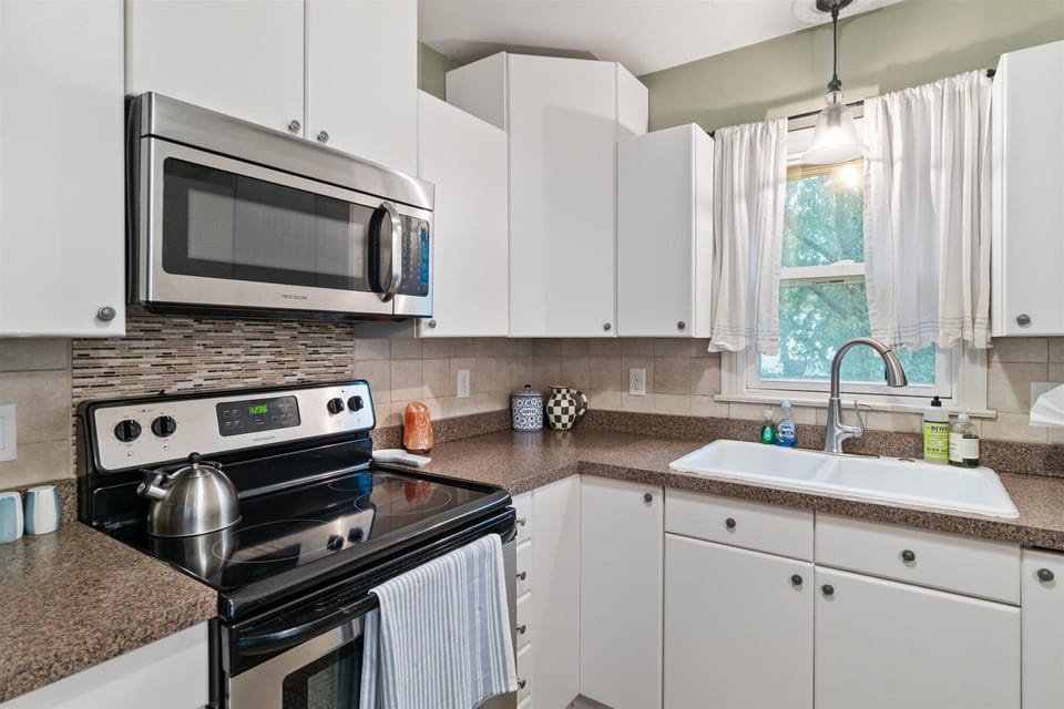 Stove, microwave, double sink and windows at the kitchen