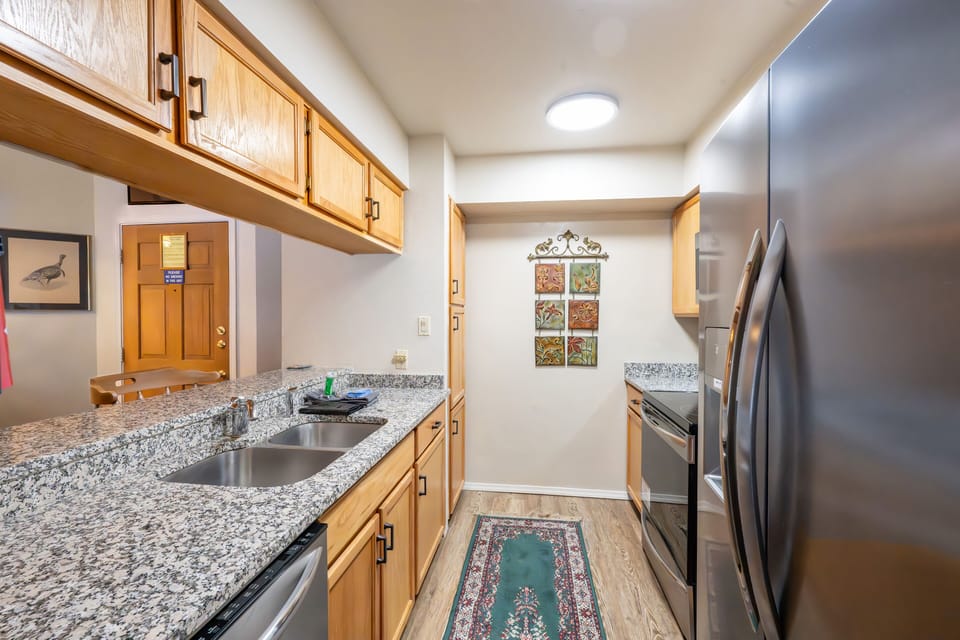 large double sinks. Stocked kitchen with everything needed to prepare any meal.