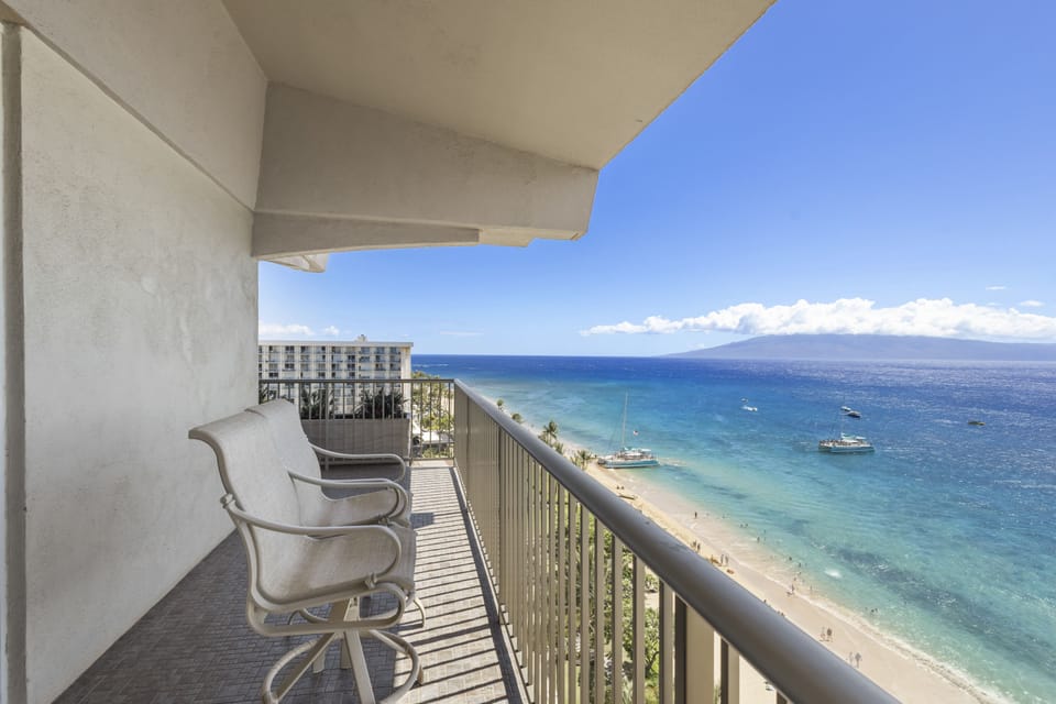 Balcony with sweeping ocean views of turquoise waters, golden sand, and distant islands—your perfect morning coffee spot or sunset retreat.