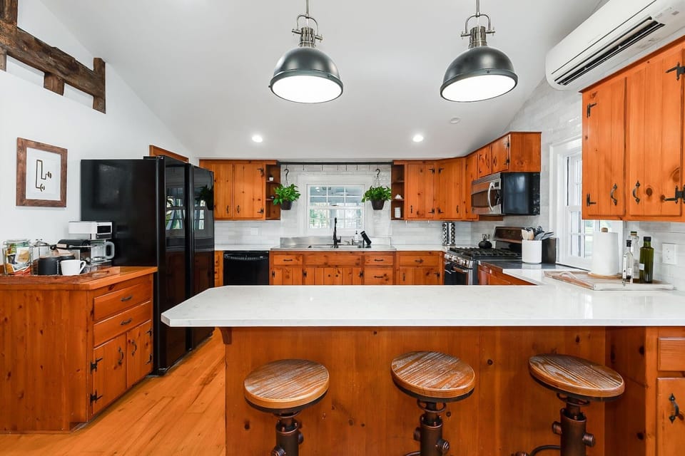 Beautifully renovated traditional farmhouse kitchen with gas stove, new dishwasher, and fully stocked for big family dinners. 