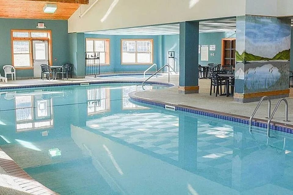 Bean shaped pool, with hot tub in the background