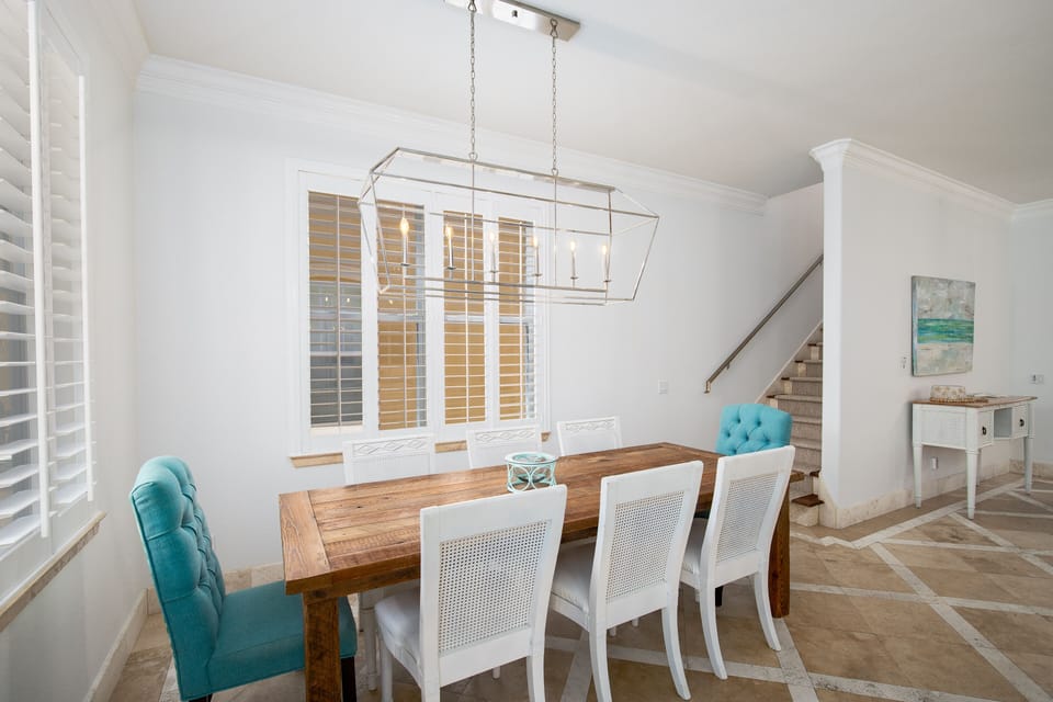 Gather around this beautiful wooden dining table where conversations flow as easily as the natural light streaming through.