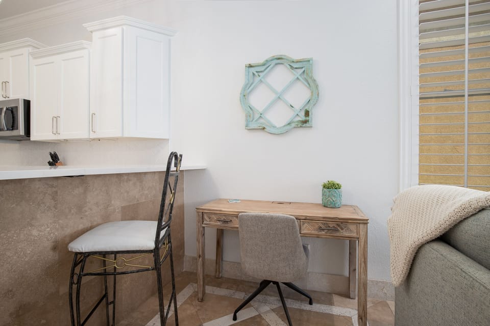 Your dedicated workspace features a charming wooden desk with coastal-inspired décor, perfect for catching up on emails or planning tomorrow's adventures.