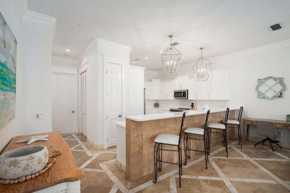 Your bright, open kitchen features elegant pendant lighting and a spacious breakfast bar where you can start each morning with coffee.