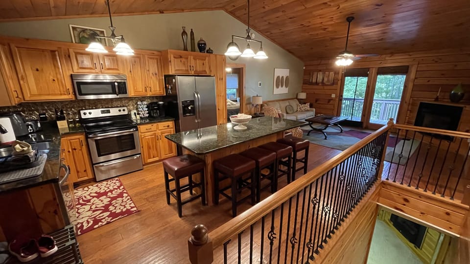 Warm wood interior featuring full kitchen, dining island, and open living space.