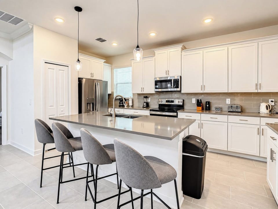 Modern kitchen with breakfast bar island and stainless appliances