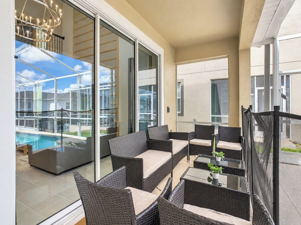 Covered Patio Lounge with Cushioned Wicker Seating