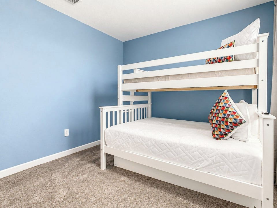 Cheerful Bedroom with White Bunk Bed and Blue Accent Walls