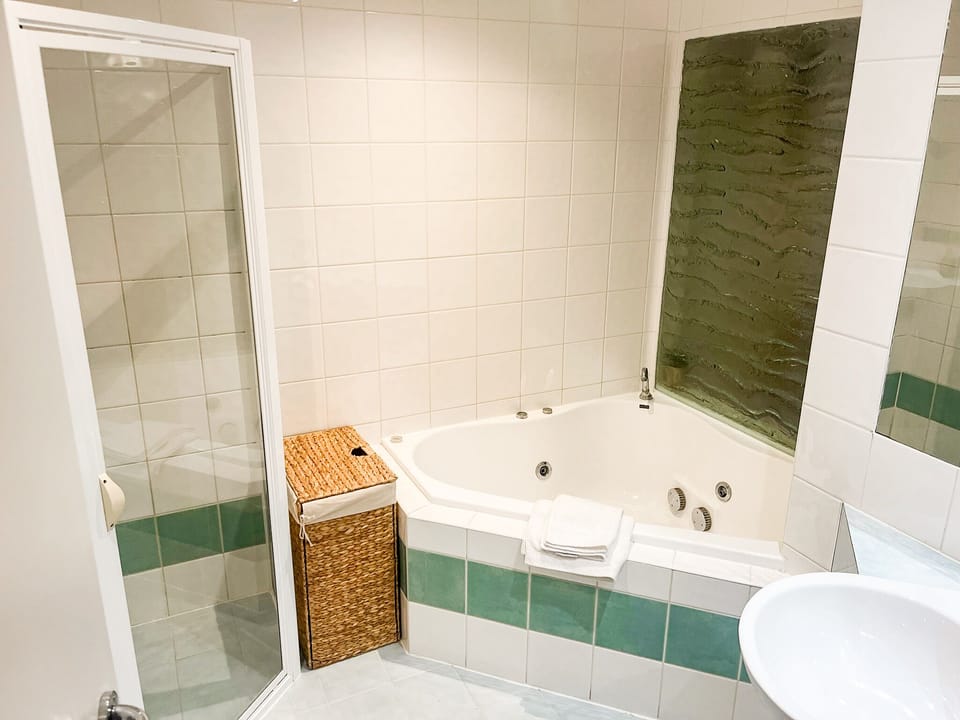 Bathroom with shower and spa bath