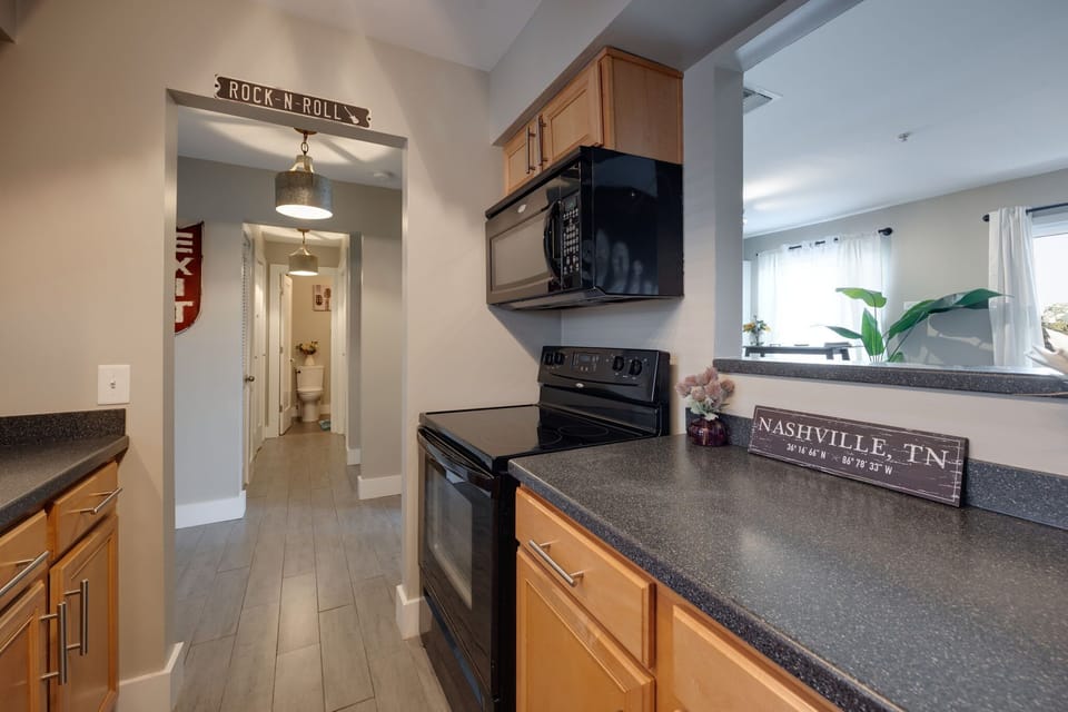 The combination of stainless steel appliances and wooden cabinets creates a perfect balance of contemporary and classic design in this kitchen.