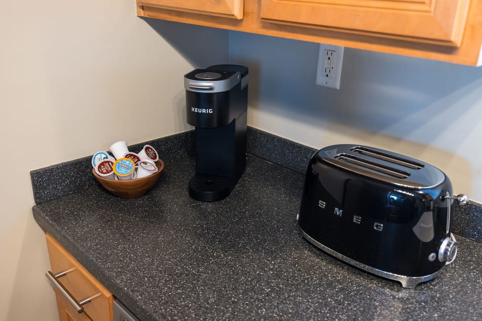 The perfect trio for a quick and easy meal prep: toaster, microwave, and refrigerator all within arm's reach.