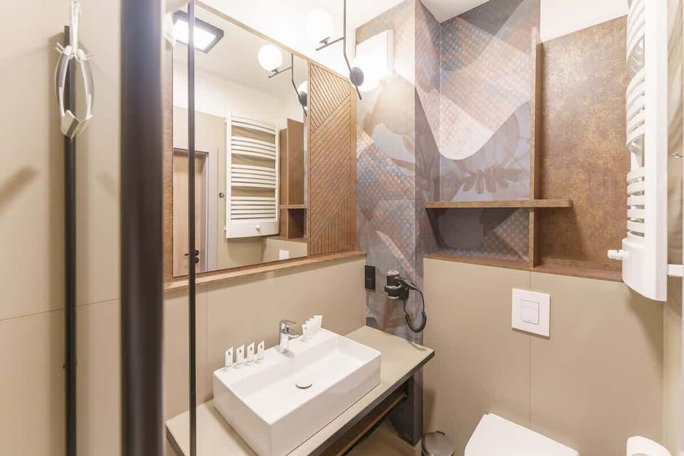 Another angle of the bathroom showcasing the sink, mirror, and elegant finishes.
