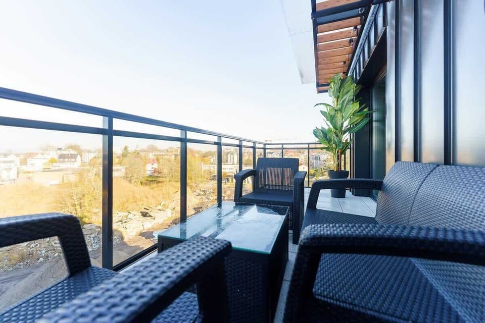 A detailed view of the balcony seating area, highlighting its modern design and views of the surrounding area.
