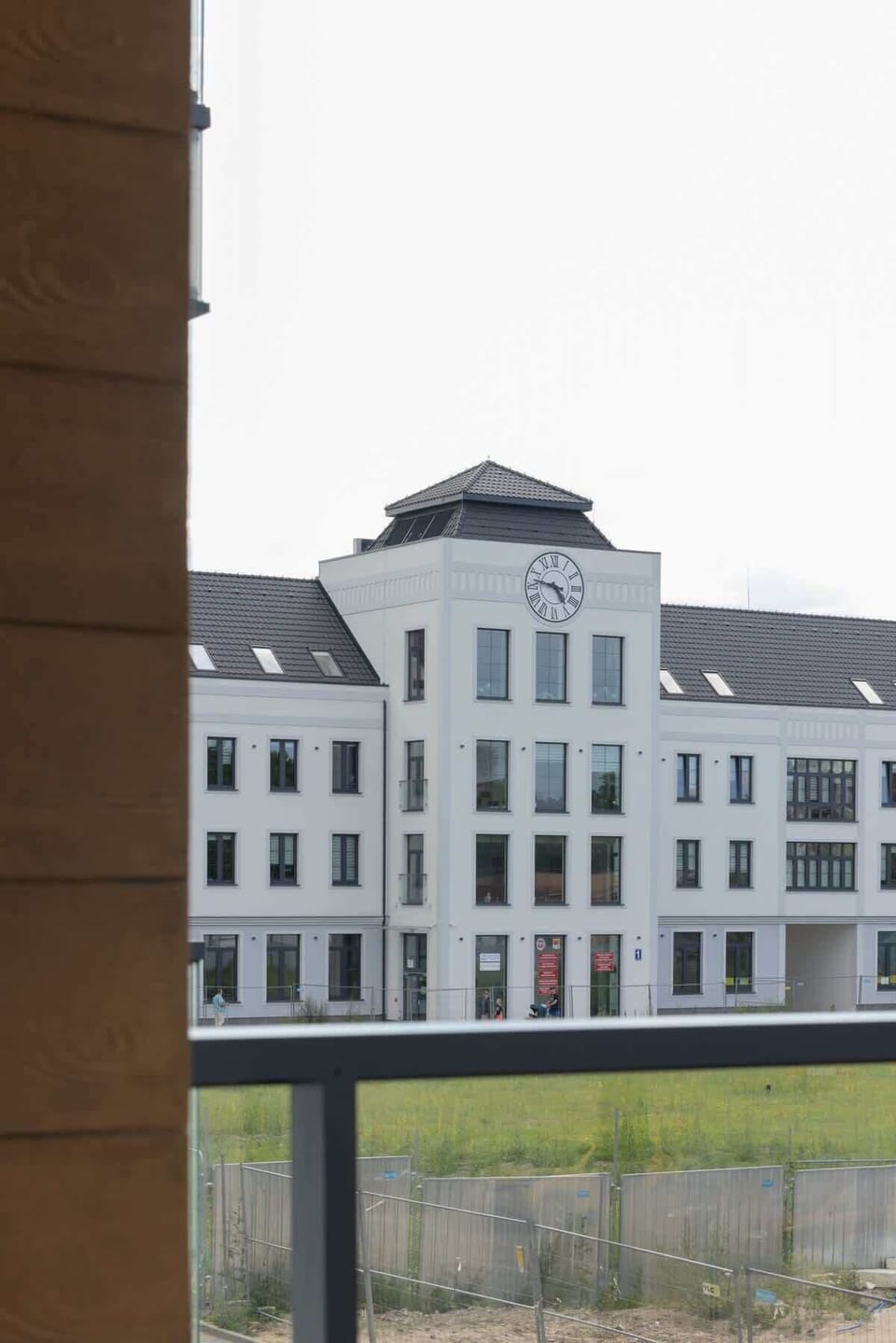 A close-up of an adjacent building with modern architectural details and urban surroundings.
