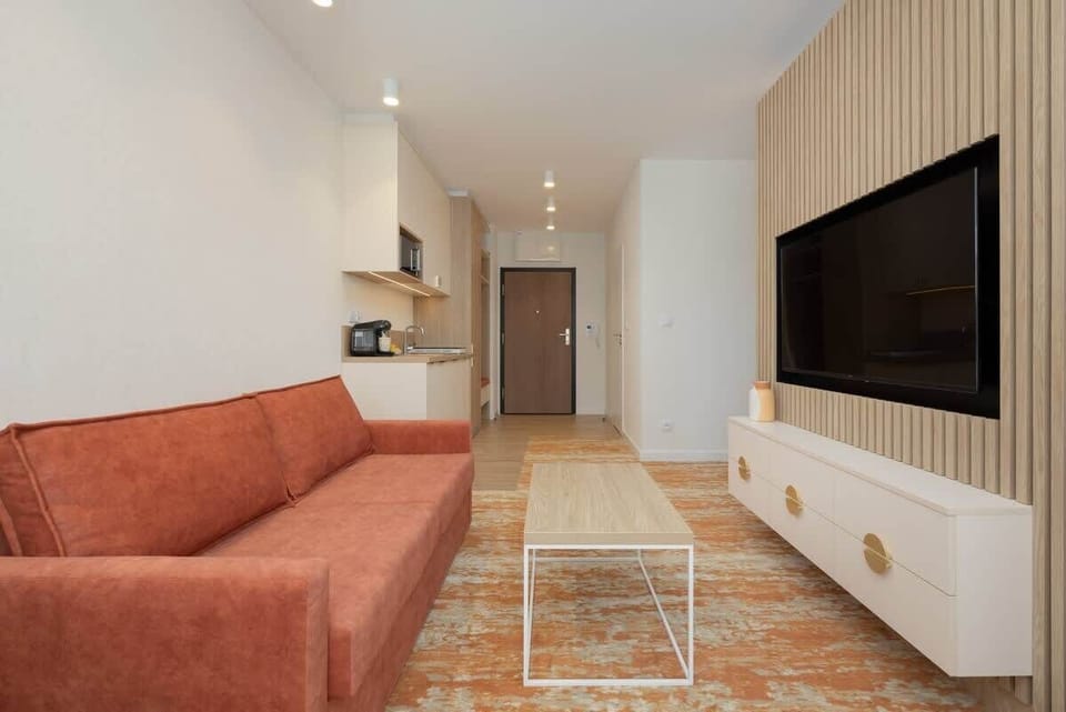 Another angle of the living space, showcasing the warm color palette, decorative elements, and cozy furniture arrangement.






