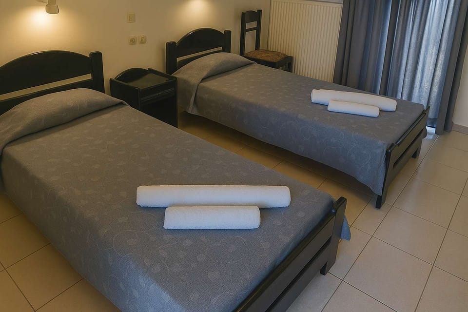 Twin Room with Minimal Design and Grey Sheets

