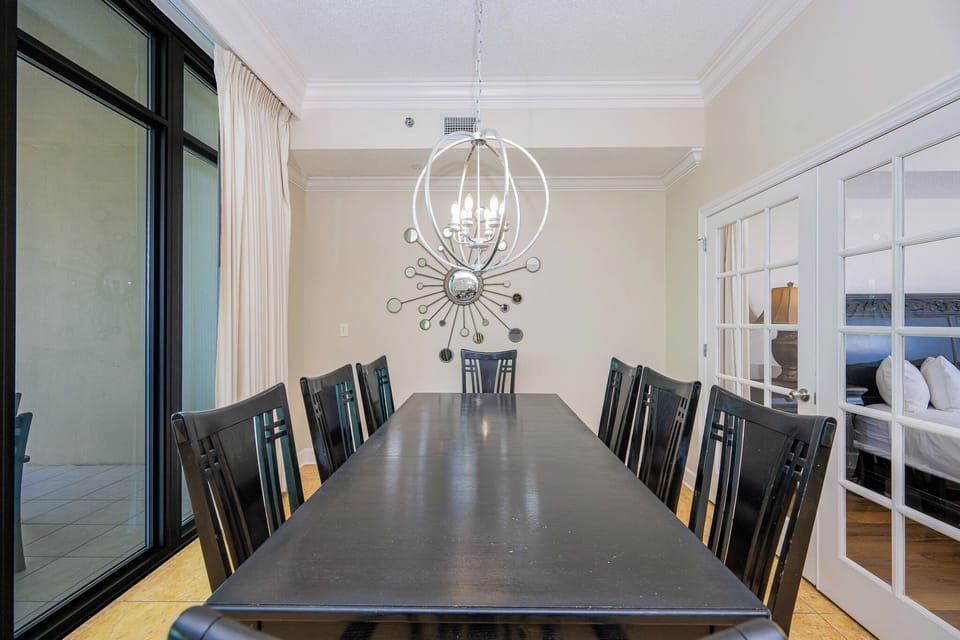 Gather around the sleek dining table, sharing stories and laughter as natural light pours in from the coastal views