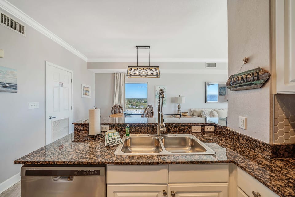 The fully equipped kitchen features granite countertops and stainless-steel appliances.