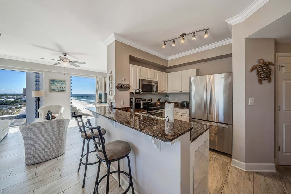 The fully equipped kitchen features granite countertops and stainless-steel appliances.