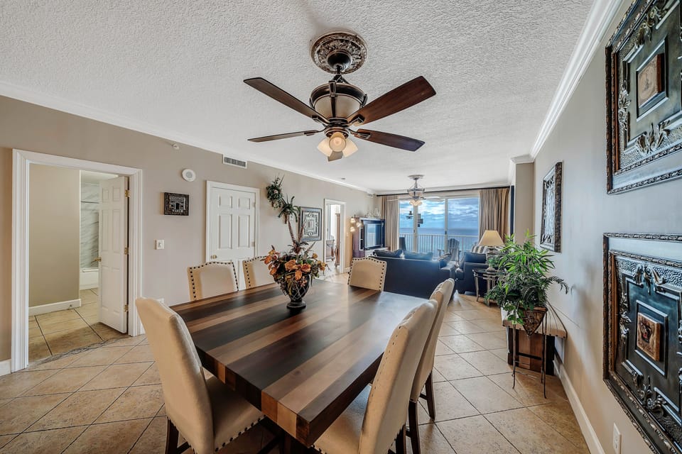 There is a large dining table as well as additional bar counter seating.