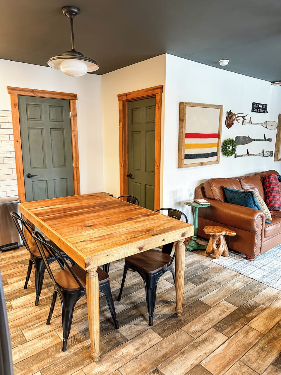 This open-concept kitchen and living area at Whispering Pines is designed for connection—whether you're cooking, chatting by the fire, or catching a movie, everyone can be part of the fun