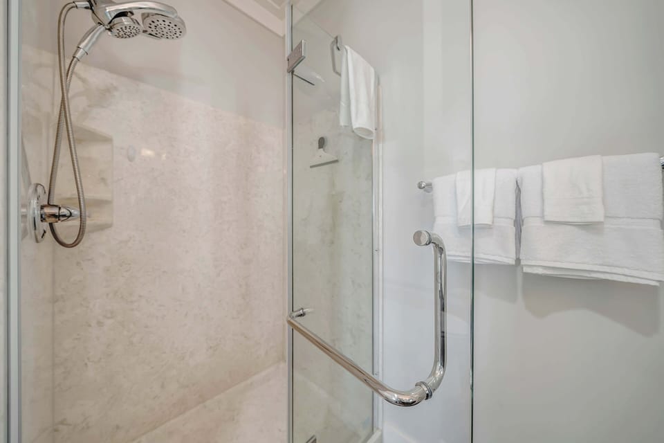 Ensuite master bathroom with double sinks and spacious walk-in shower.