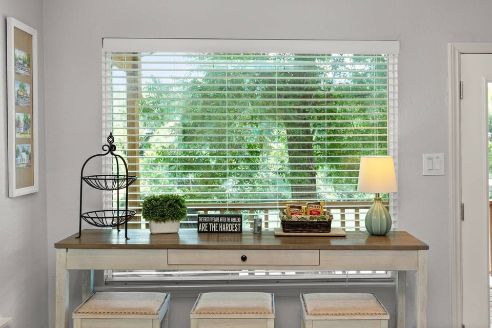 This versatile table offers a stunning view of the Guadalupe River, perfect for dining or a peaceful work-from-vacation setup.