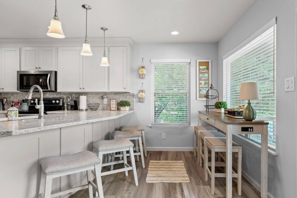 Enjoy meals and conversation at the bright and open kitchen bar with comfortable stool seating.