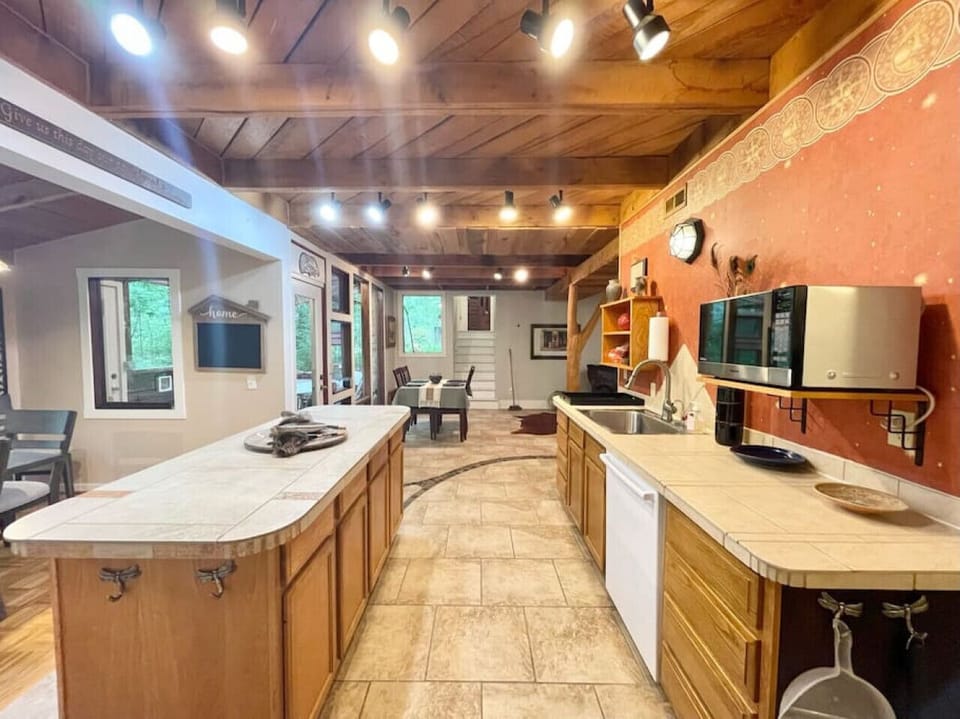 Kitchen fully stocked with all cooking essentials, oven, dishwasher, microwave, stove and drop coffee maker