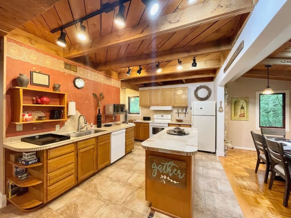 Kitchen fully stocked with all cooking essentials, oven, dishwasher, microwave, stove and drop coffee maker