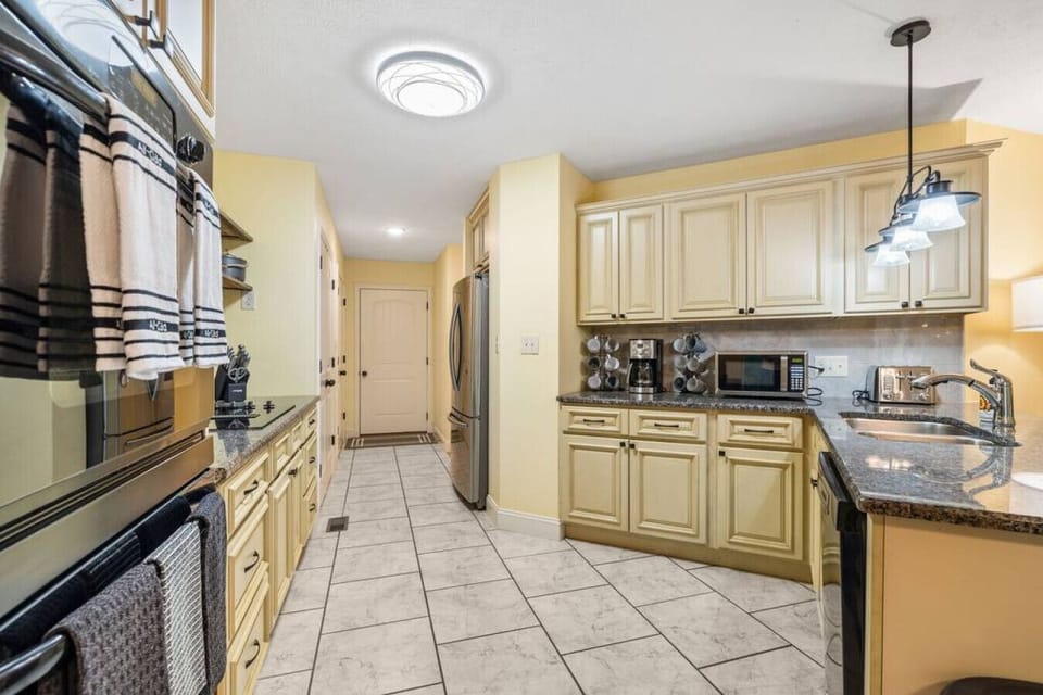 Kitchen has pots, pans, coffee pot, microwave, etc