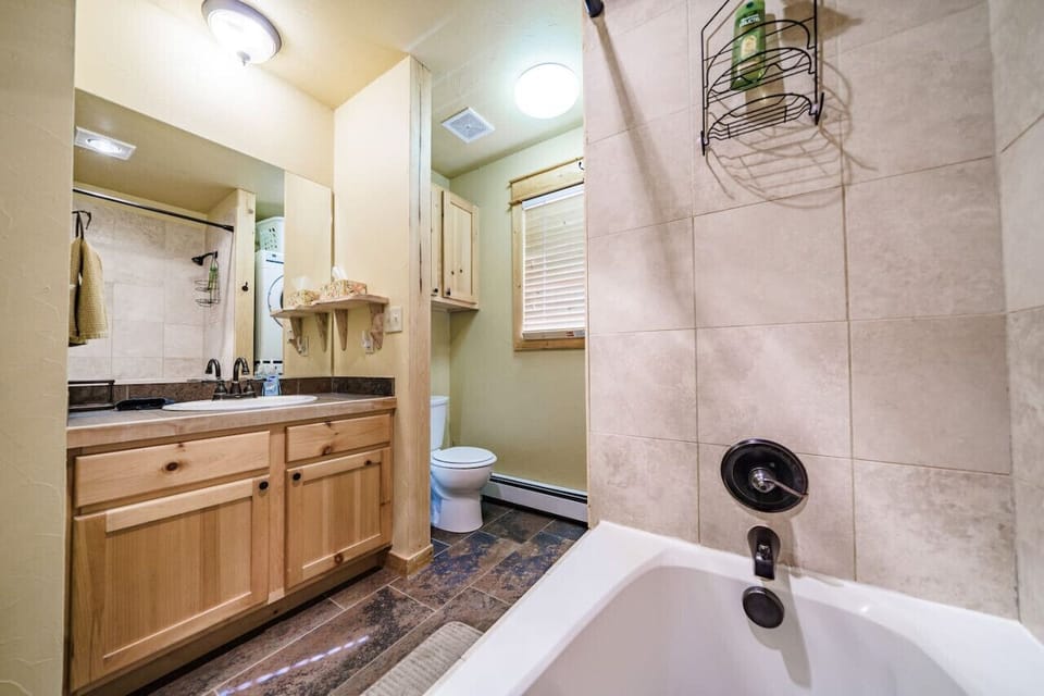 A full bathroom with a tub and shower gives everyone plenty of room to get ready for the day`s adventures.