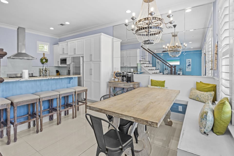 Your open-concept living flows beautifully from kitchen to dining, with elegant chandeliers and a cozy seating nook perfect for morning coffee.