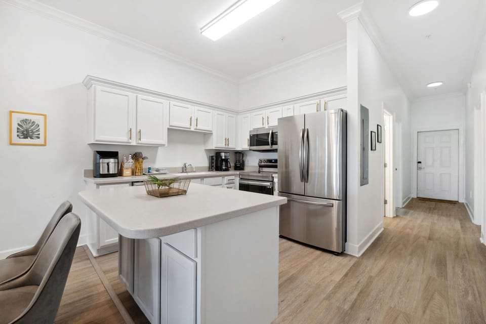 Open kitchen with middle island and stainless steel appliances