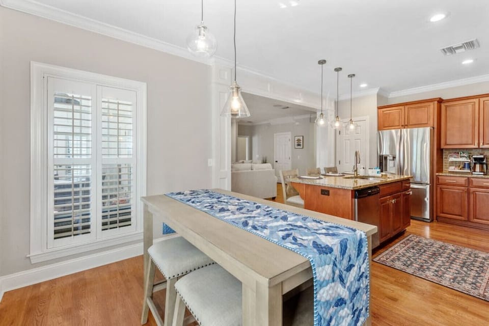 Transform your kitchen into a cozy hangout with a chic bar table, complete with bar seating, making it the perfect spot for casual dining or morning coffee.
