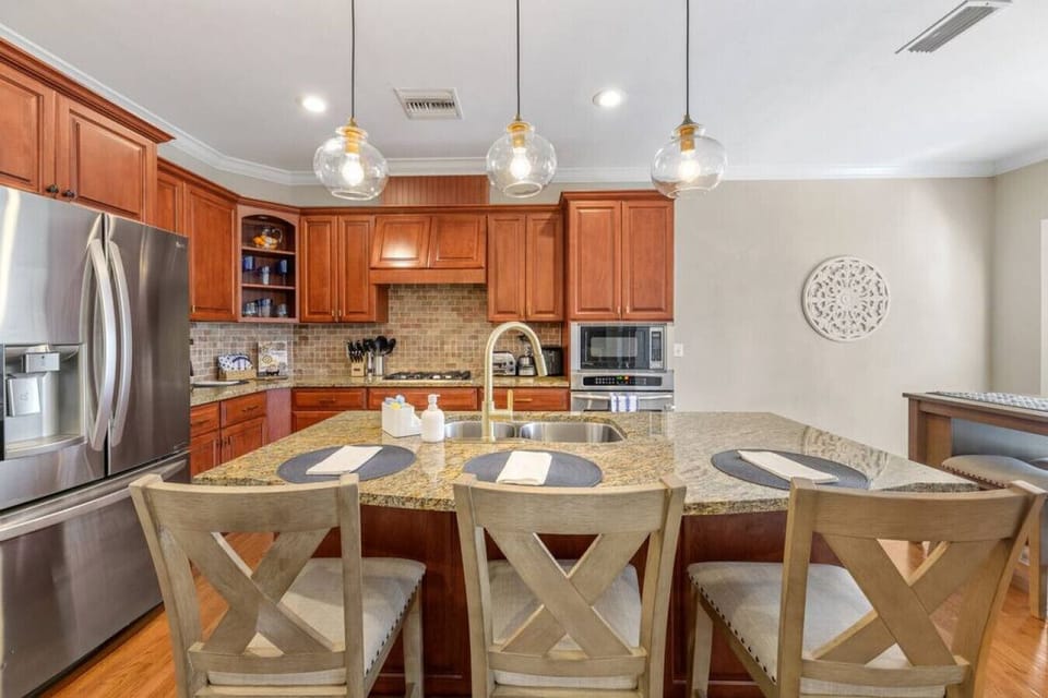 Discover the heart of the home in this fully equipped kitchen, where a spacious island with bar seating for three transforms meal preparation into a social experience.