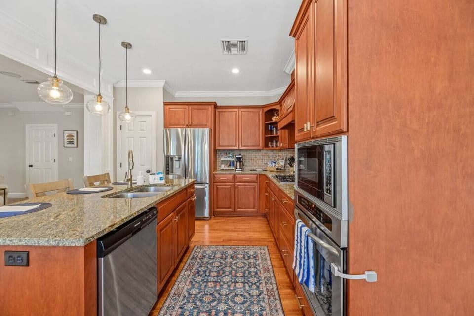 Step into a fully equipped kitchen where the mid-century modern interior takes center stage, with a stylish kitchen island that combines functionality and timeless design.