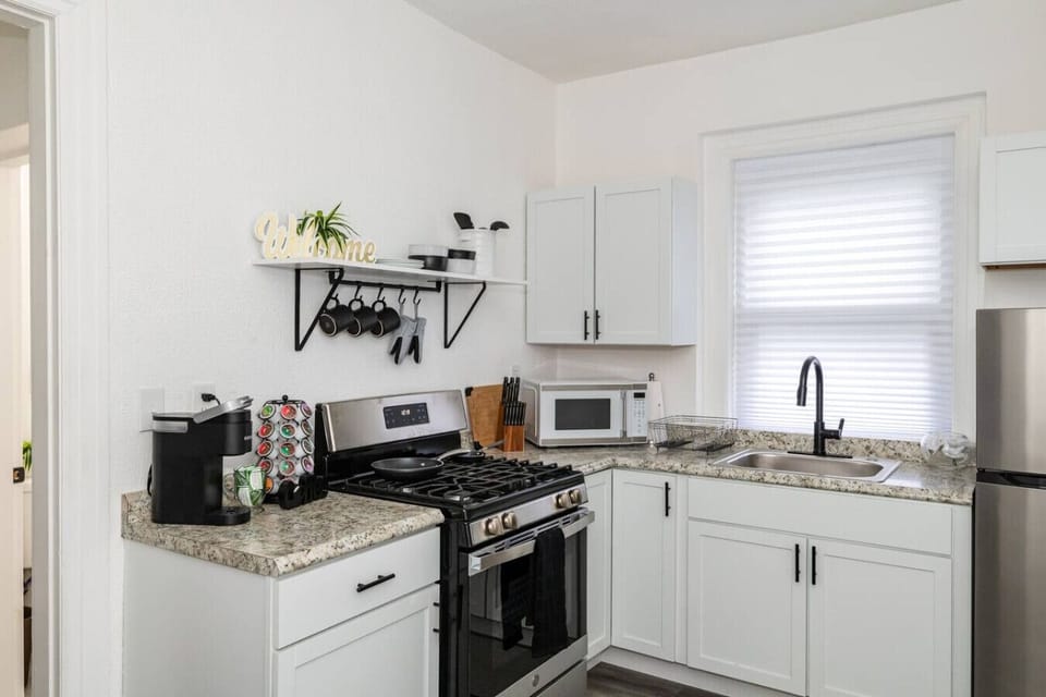 Stocked kitchen with cookware and utensils