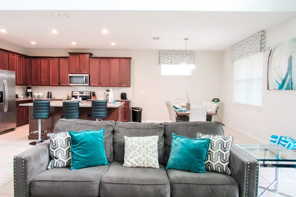 Open plan kitchen and family room, adjacent to wet bar for use from pool