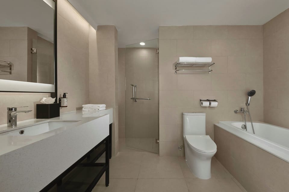 Executive Suite, 1 Bedroom | Bathroom | Shower, free toiletries, hair dryer, slippers