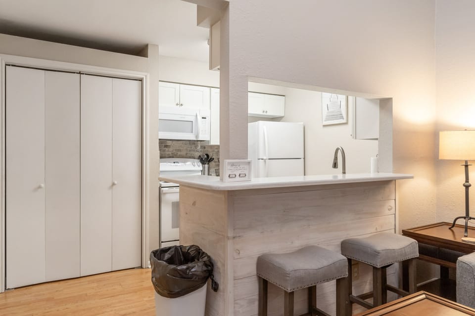 Your fully equipped kitchen features modern appliances and a breakfast bar where you can enjoy morning coffee and plan adventures.