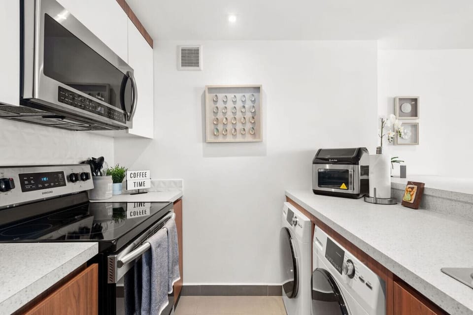 Modern kitchen with washer & dryer, refrigerator, stove and microwave