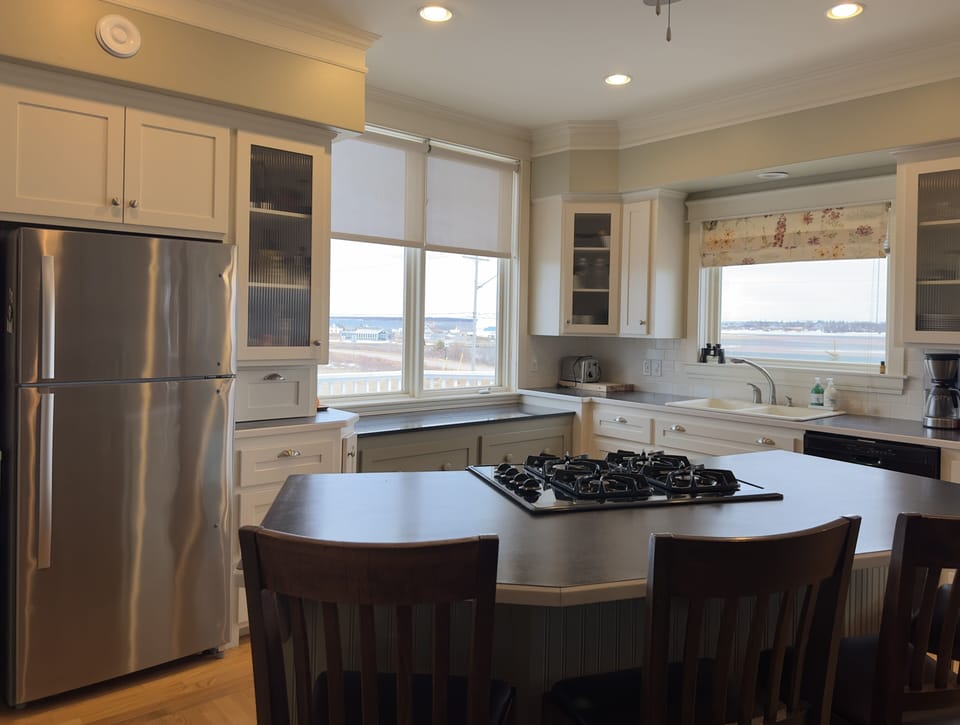 Kitchen with gas stove/oven, dishwasher and double sided fireplace