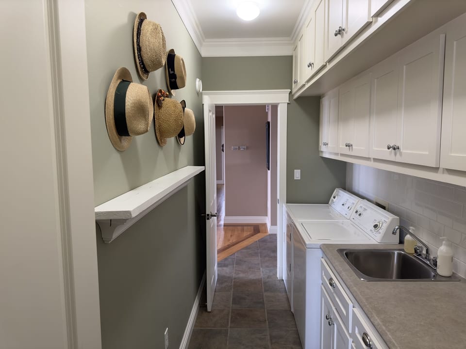 Walk-through pantry and laundry room between the kitchen and front entryway