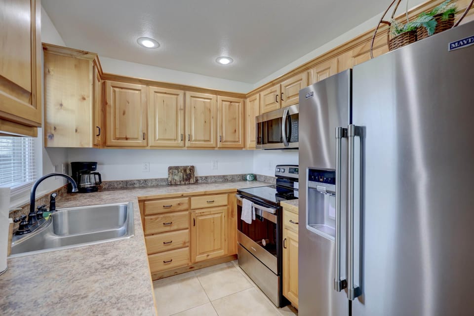 Eating in is no problem with this standard galley kitchen stocked with all your basic needs.